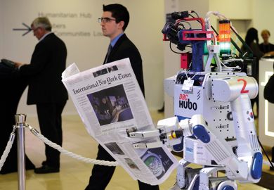 A robot holds a newspaper during a demonstration at the World Economic Forum (WEF) annual meeting in Davos A robot holds a newspaper during a demonstration at the World Economic Forum (WEF) annual meeting in Davos