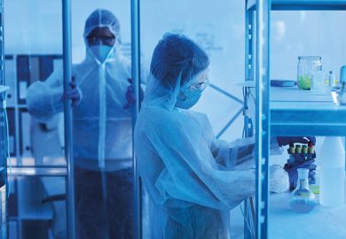 male medical scientist in protective workwear opening door to laboratory room male medical scientist in protective workwear opening door to laboratory room