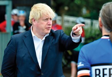 Britain's Prime Minister Boris Johnson (L) gestures as he talks to members of a local cycling club at the Canal Side Heritage Centre in Beeston, central England, on July 28, 2020