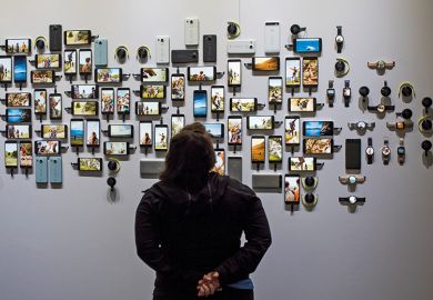 A person looking at various smart phones A person looking at various smart phones