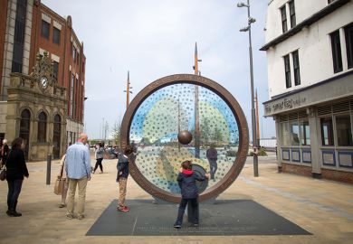 Pedestrians look at the The Keel Line memorial, built to remember Sunderland's shipping industry in Sunderland, U.K