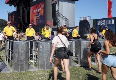 Music fans and security staff at the newly installed crowd control barriers at the Main Stage during day one of Reading Festival 2019