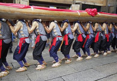 24 seniors villagers carry a giant wooden pillar ("long zhu" in Chinese) on their shoulders to celebrate the 11th China's Cultural Heritage Day on June 11, 2016 in Fuzhou, Fujian Province of China