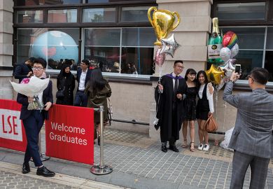 Friends and family of a 21 year-old Law graduate from Hong Kong, celebrate her graduation with a 2:1 degree outside the London School of Economics