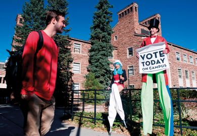 Person on stilts encourages students on the University of Colorado campus to vote Person on stilts encourages students on the University of Colorado campus to vote