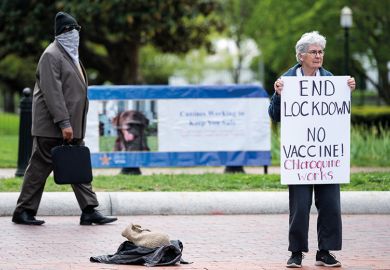 A lone protester holds a sign calling for an end to the lockdown and claiming chloroquine works as she stands in front of the White House in Washington on Saturday, April 25, 2020. A lone protester holds a sign calling for an end to the lockdown and claiming chloroquine works as she stands in front of the White House in Washington on Saturday, April 25, 2020.