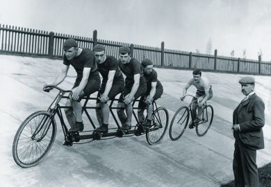 A four-man cycling tandem team in training with the 'chase and pacemaker' whilst being timed on the stopwatch. A four-man cycling tandem team in training with the 'chase and pacemaker' whilst being timed on the stopwatch.