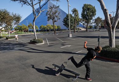 Long Beach, CA, Monday, September 29, 2020 - man skateboards in an empty parking lot at Cal State Long Beach where five students tested positive for Covid-19.