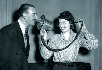 Woman demonstrating a Chase silver ear trumpet, made in 1880 and used by Queen Victoria, at the 'Escape From Deafness' exhibition in Park Lane House, Park Lane, London. Woman demonstrating a Chase silver ear trumpet, made in 1880 and used by Queen Victoria, at the 'Escape From Deafness' exhibition in Park Lane House, Park Lane, London.