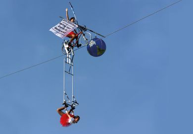 Tightrope artists balance a globe