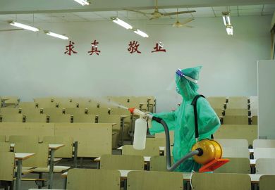 Worker sprays disinfectant inside a classroom of Zhejiang A&F University, August 2021 Worker sprays disinfectant inside a classroom of Zhejiang A&F University, August 2021