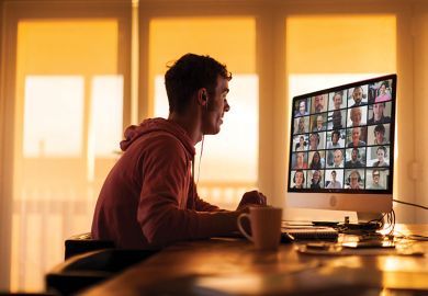 Man looking at computer screen with video conferencing