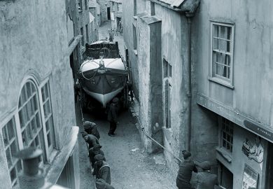 The Port Isaac Cornwall lifeboat being dragged through the very narrow streets of the town at its launch.