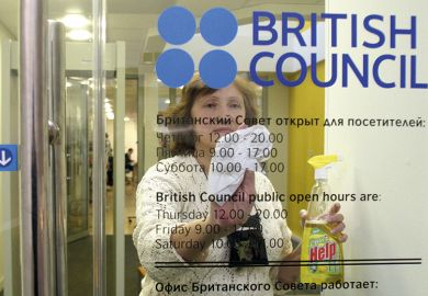 A woman cleans a door of the British Council office in St Petersburg