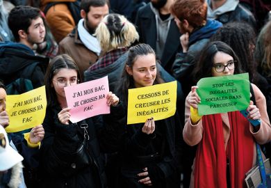 Students hold banners reading "I passed my high school diploma (Baccalaureat or Bac in French), I get to choose my university" and "Stop widening inequalities" during a demonstration march at Place Saint-Michel, Paris, France, on December 11, 2018