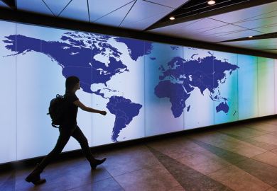 Person walking past map of the world Person walking past map of the world
