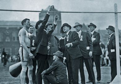 Officials measuring the high jump