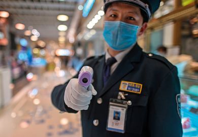 A guard wearing a facemask amid concerns over the spread of the COVID-19 novel coronavirus, holds a thermal gun to check the body temperature of visitors at the entrance of a restaurant area in Shanghai, on March 21, 2020. A guard wearing a facemask amid concerns over the spread of the COVID-19 novel coronavirus, holds a thermal gun to check the body temperature of visitors at the entrance of a restaurant area in Shanghai, on March 21, 2020.