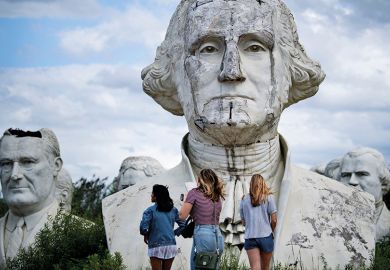 People tour the decaying remains of salvaged busts of former US Presidents Lyndon Johnson (L) and George Washington on August 25, 2019, in Williamsburg, Virginia.
