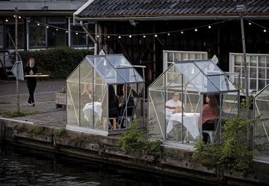 People have dinner in a so-called quarantine greenhouses in Amsterdam, on May 5, 2020 as the country fights against the spread of the COVID-19, the novel coronavirus.