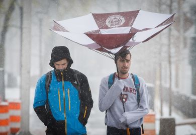 Harvard University students walk under a damaged umbrella near Harvard Square in Cambridge, MA in April Harvard University students walk under a damaged umbrella near Harvard Square in Cambridge, MA in April