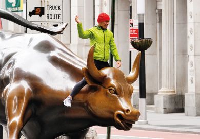A person can be seen riding the Charging Bull in the financial distrcict  of New York City amid Coronavirus pandemic on April 5, 2020.