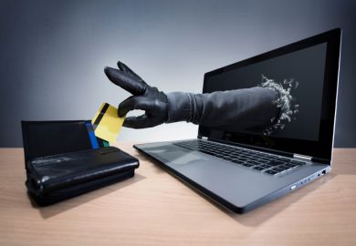 A hand comes out of a computer screen and steals a credit card A hand comes out of a computer screen and steals a credit card