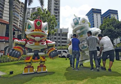 Workers carry a robot anime figure depicting the mask of a lion dance named "Lunar Guardians" in an outdoor installation at the Sun Yat Sen Nanyang Memorial Hall in Singapore Workers carry a robot anime figure depicting the mask of a lion dance named "Lunar Guardians" in an outdoor installation at the Sun Yat Sen Nanyang Memorial Hall in Singapore