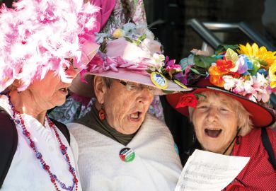 Three women singing from same hymn sheet