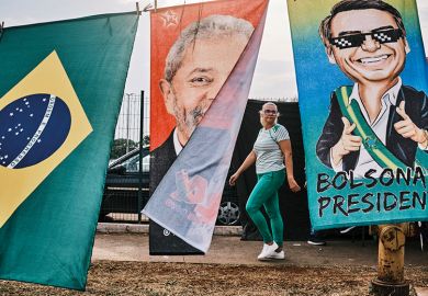 A woman walks by flags of Brazilian presidential candidates Luiz Inácio Lula da Silva and Jair Bolsonaro A woman walks by flags of Brazilian presidential candidates Luiz Inácio Lula da Silva and Jair Bolsonaro