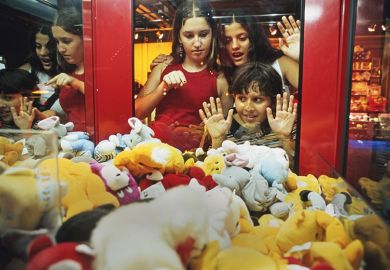 Children look at soft toys