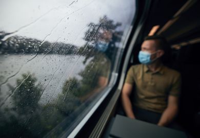 Passenger on a train wearing a face mask Passenger on a train wearing a face mask