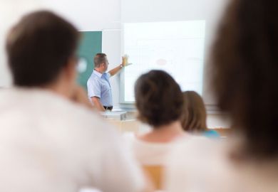 Trainee teachers studying in classroom