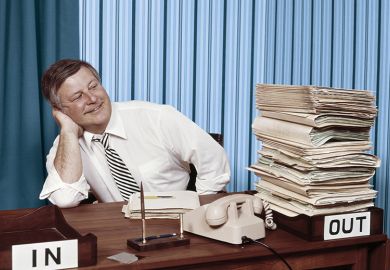 Office worker satisfied with full out tray and empty in tray on desk Office worker satisfied with full out tray and empty in tray on desk