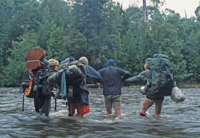 Trekkers crossing river, Tarkine rainforest