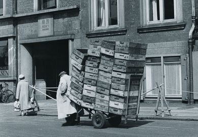 man pulls a heavy trolley