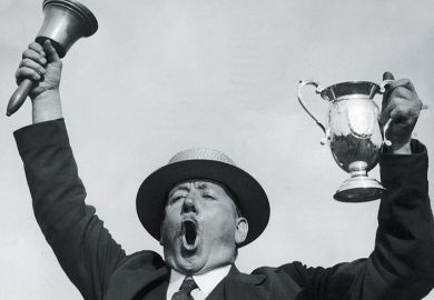Man ringing bell while holding trophy