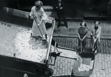 Woman sweeping coins into a wheelbarrow Woman sweeping coins into a wheelbarrow