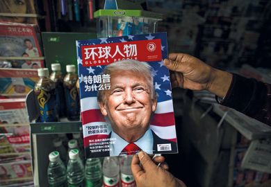 A Chinese magazine with a cover story that translates to "Why did Trump win" is seen with a front cover portrait of Donald Trump