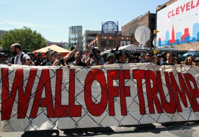Cleveland, Ohio, USA - July 20, 2016: Participants in the 'Wall Off Trump' immigration march and rally demonstrate outside the Quicken Loans Arena, site of the Republican National Convention, on its third day.  Cleveland, Ohio, USA - July 20, 2016: Participants in the 'Wall Off Trump' immigration march and rally demonstrate outside the Quicken Loans Arena, site of the Republican National Convention, on its third day.