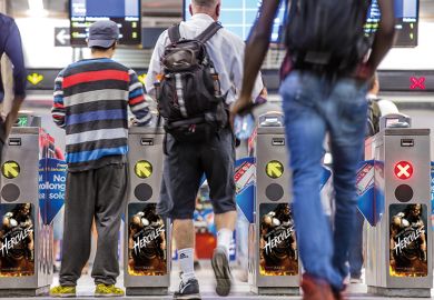 People passing through turnstiles