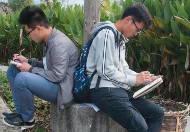 Two male art students sketching back-to-back, Hongcun village, Anhui, China Two male art students sketching back-to-back, Hongcun village, Anhui, China