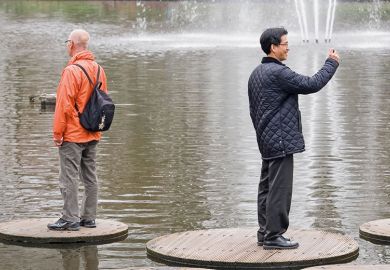 two men stand back to back