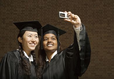 Two female graduates taking a photograph
