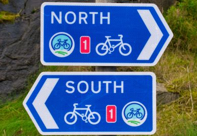 Two white on blue signs for the UK National Cycle Route 1 in Lerwick, Shetland, Scotland, UK - one pointing North, the other pointing South. stock photo
