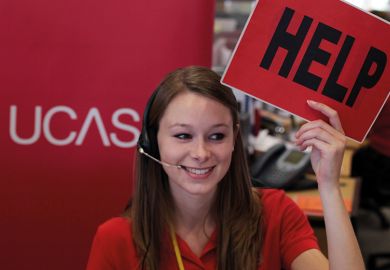 An employee in the UCAS clearing house call centre calls for assistance and advice from a supervisor