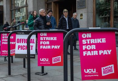 University and College Union (UCU) posters demanding fair pay are pictured at an official picket