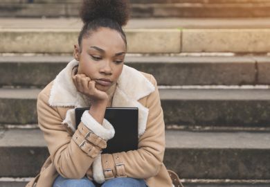 An unhappy black student waiting
