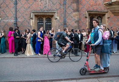 University of Cambridge students going to the Trinity College May Ball, as people ride past on a scooter. To illustrate that elite universities admit fewer local students as intakes grow.