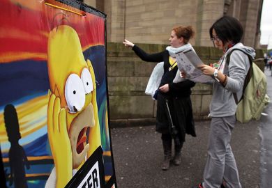 Students arriving for freshers week at the University of Manchester consult their campus map, with a picture of Homer Simpson in despair. To illustrate the shock that certain universities such as Manchester have missed out from the Global Talent Fund.